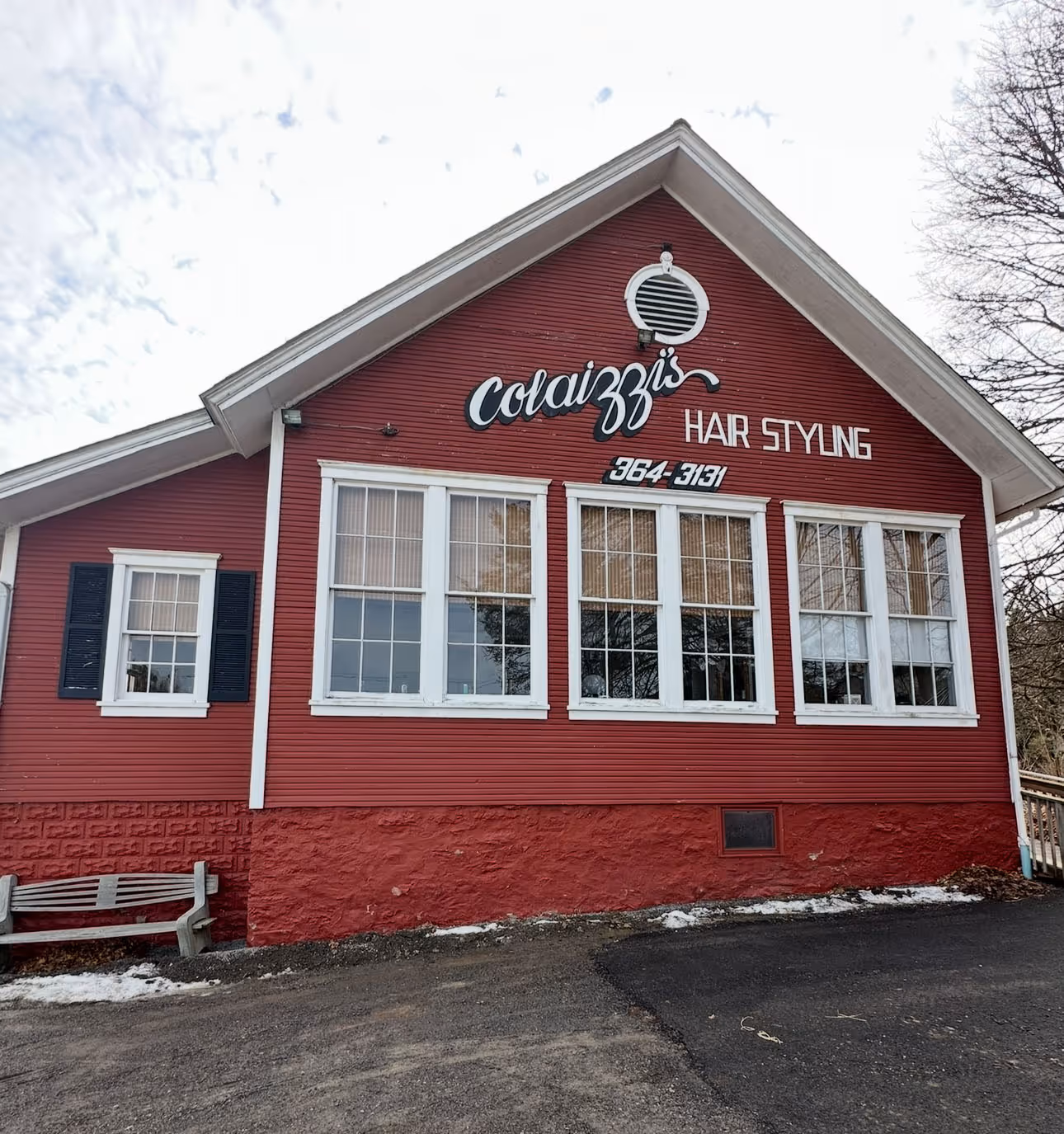 Red building with white trim housing Colaizzi's Hair Styling salon with phone number 364-3131.